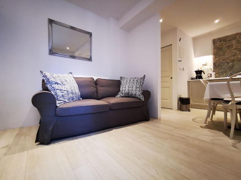 a living room with a brown couch and a table at ROMANTIC APARTMENT Lovran - 4 stars in Lovran