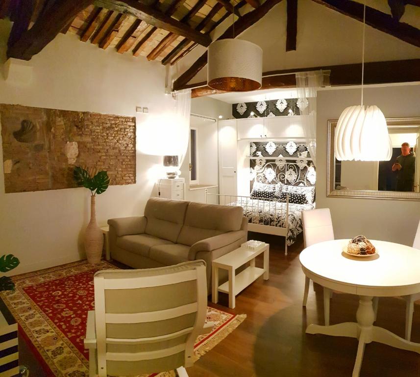a living room with a couch and a table at La Casa nel Castello in Ostia Antica