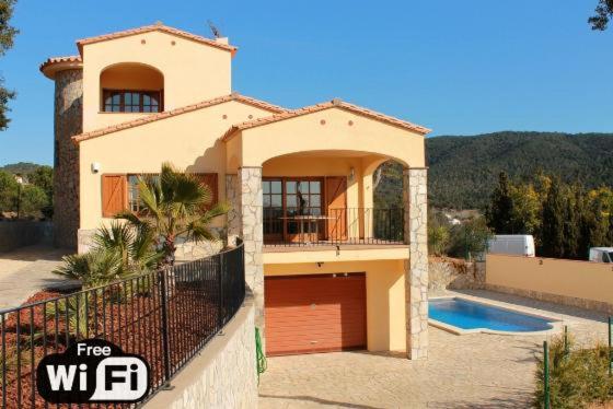 a large house with a garage and a swimming pool at Villa Catalana in Calonge