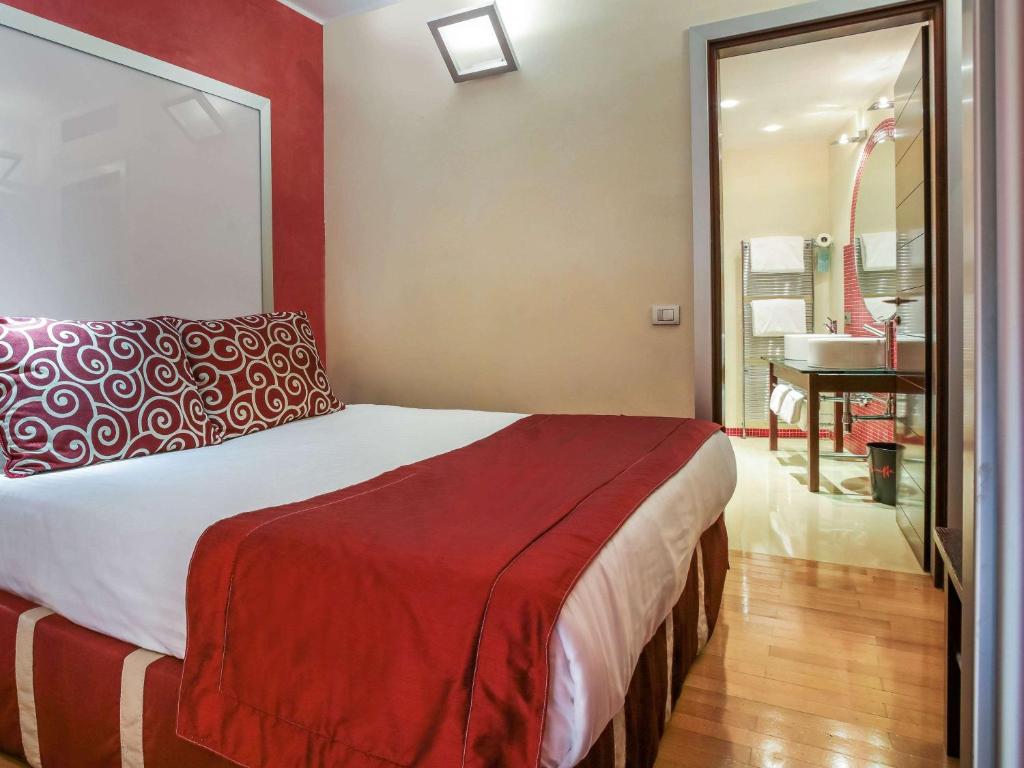 Cama o camas de una habitación en La Griffe Hotel Roma
