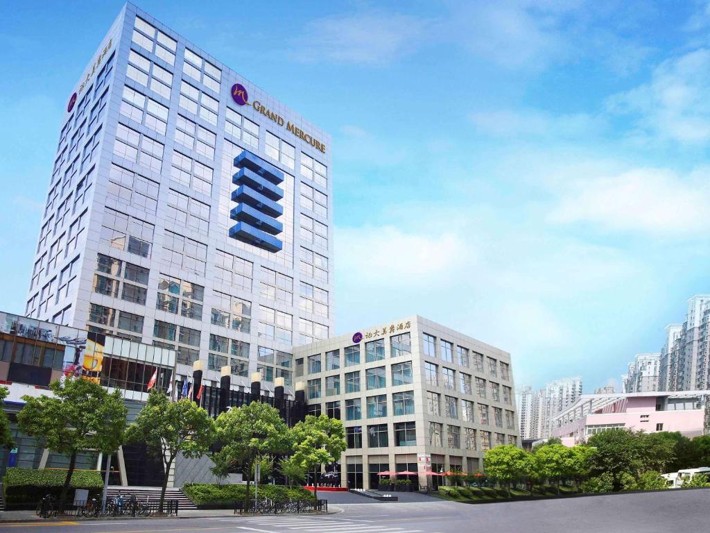 a large building with a sign on the side of it at Grand Mercure Shanghai Century Park - Free shuttle bus to SNIEC in Shanghai