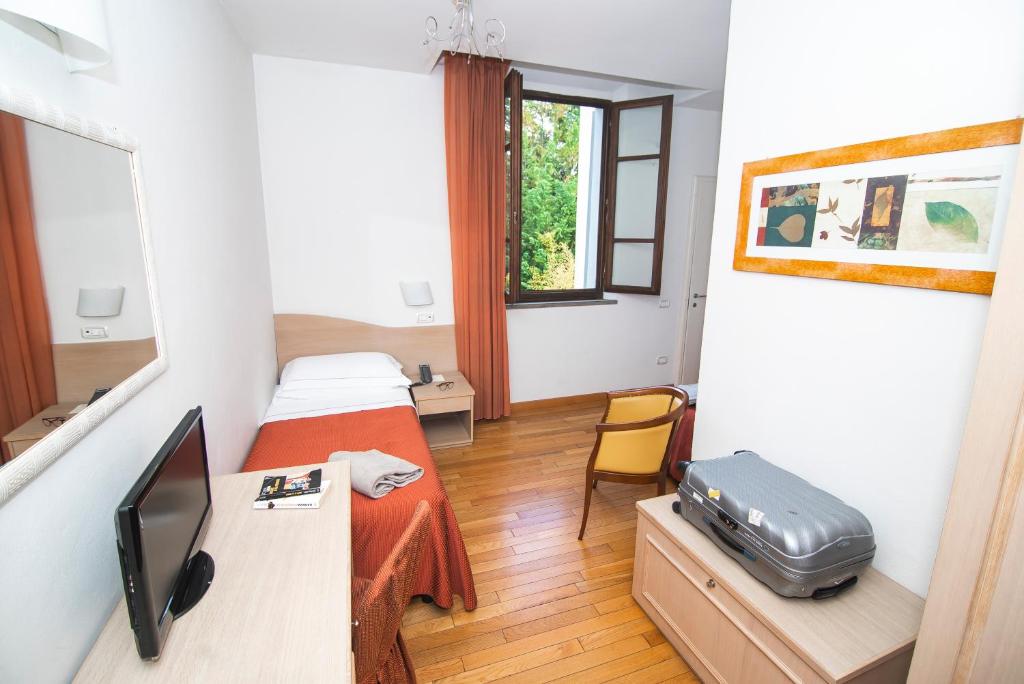 Postel nebo postele na pokoji v ubytování Hotel La Colonna
