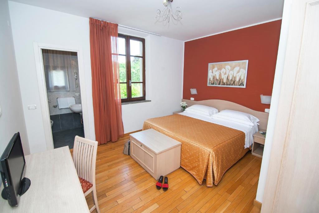 Postel nebo postele na pokoji v ubytování Hotel La Colonna