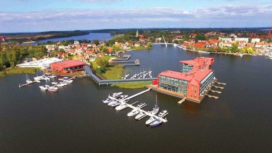 an aerial view of a marina with boats in the water at Kameralne domki w Mikolajkach in Mikołajki