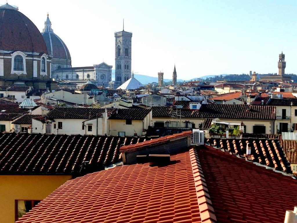 a view of a city with roofs of buildings at Soggiorno Rubino in Florence