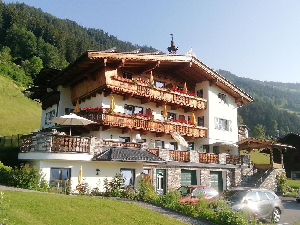 a large building with balconies on top of it at Tirol Appartement Haus Zillertal in Zell am Ziller