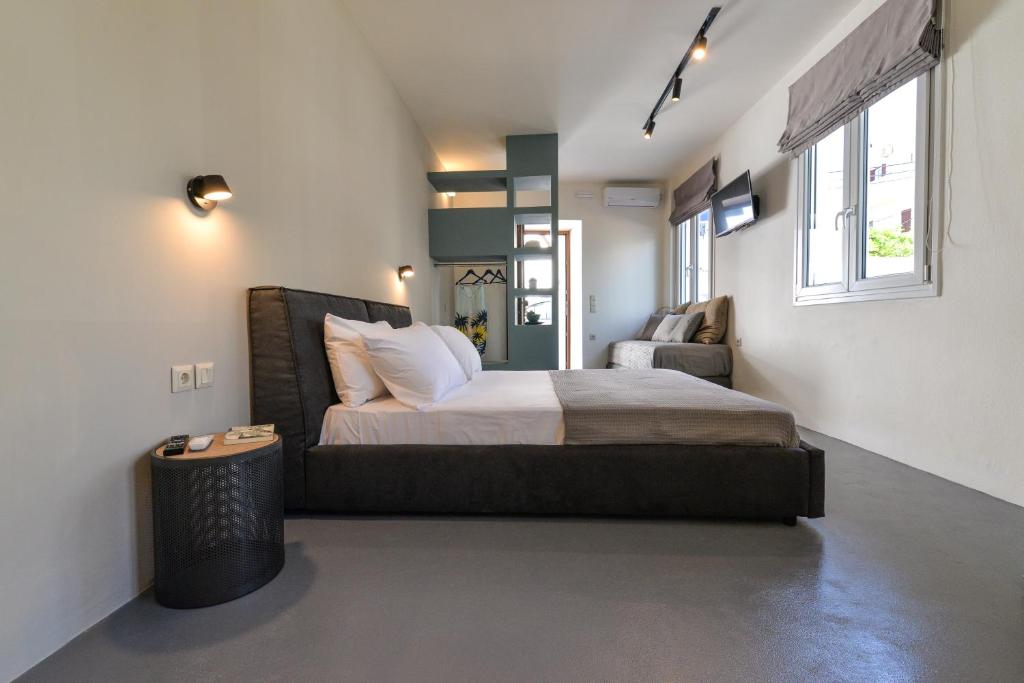 a bedroom with a large bed and a chair at Agreli hora in Tinos Town