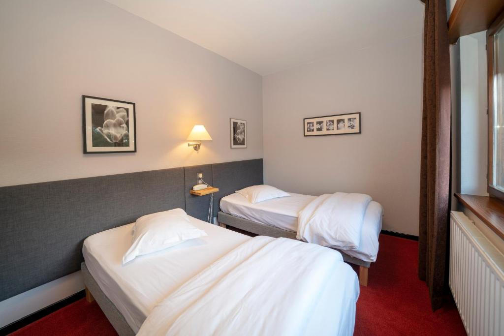 Postel nebo postele na pokoji v ubytování Hôtel Le Verger De Bischwiller