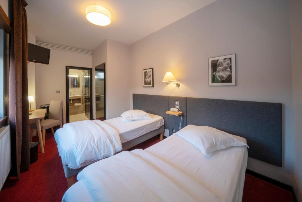 Postel nebo postele na pokoji v ubytování Hôtel Le Verger De Bischwiller