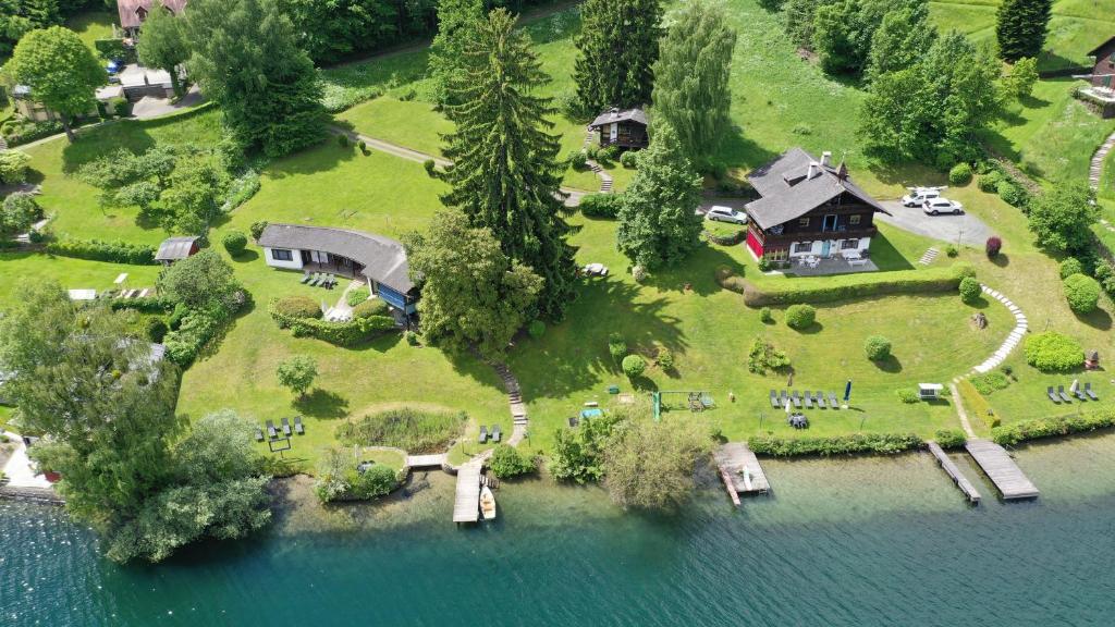an aerial view of a house on an island in the water at Waldstrand Berger in Seeboden