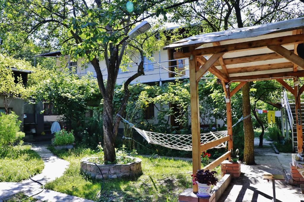 a hammock in a garden with a tree at Hotel Vardzia K A L A in Aspindza
