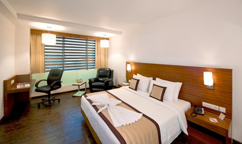 Postel nebo postele na pokoji v ubytování Hotel Sandy's Tower