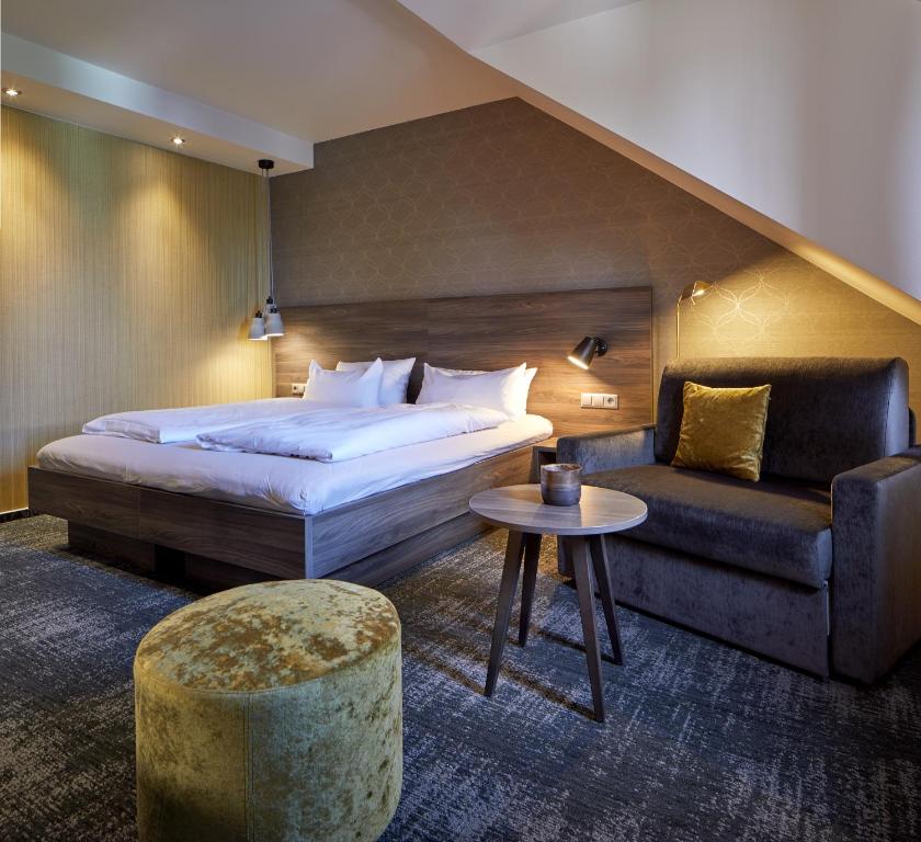Postel nebo postele na pokoji v ubytování NaturKulturHotel Stumpf