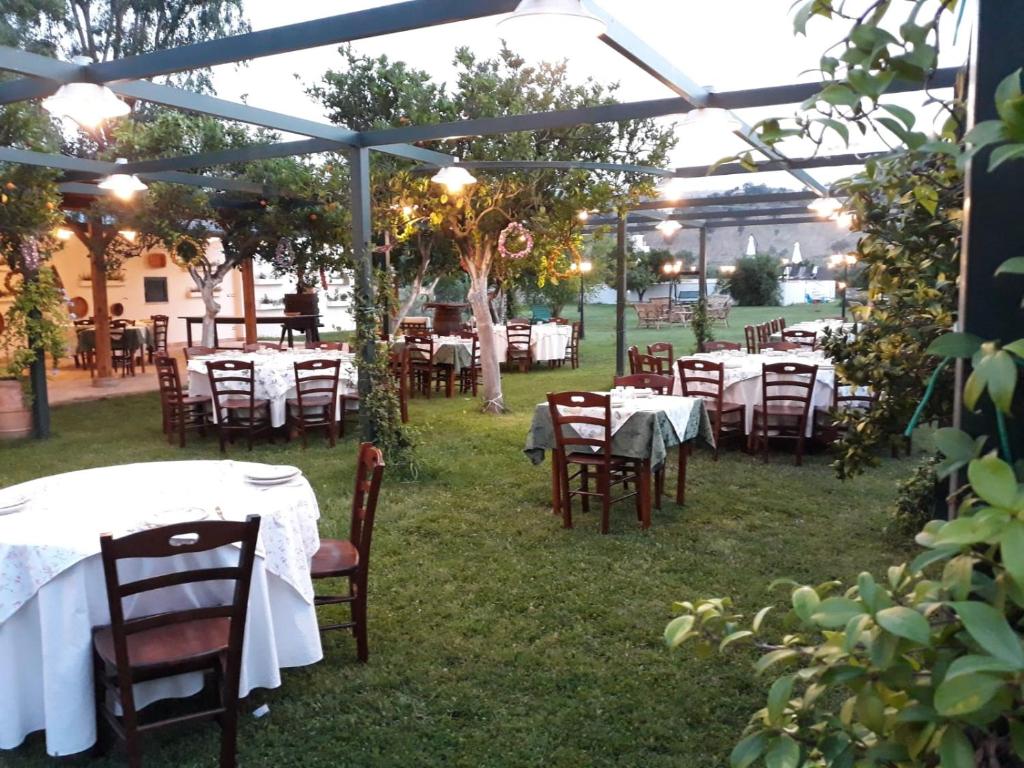 a group of tables and chairs under a tent at Agriturismo Giardino di Iti in Rossano
