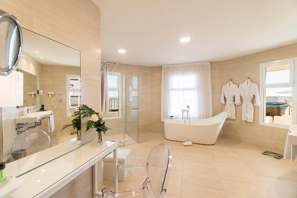 a bathroom with a tub and a sink at Royal Palm Resort & Spa - Adults Only in Playa Jandia