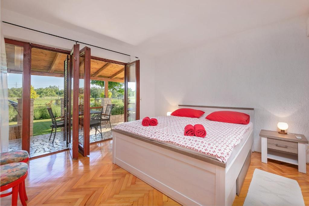 een slaapkamer met een bed met rode kussens erop bij Red Apartment in Vrsar