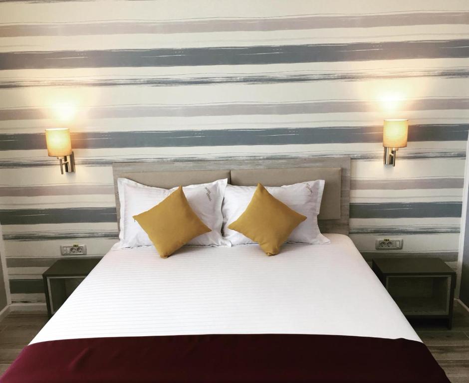 Postel nebo postele na pokoji v ubytování Hotel Dedal