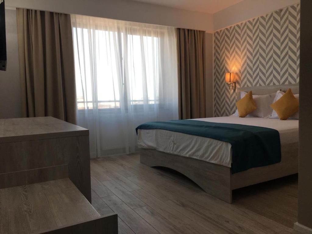 Postel nebo postele na pokoji v ubytování Hotel Dedal