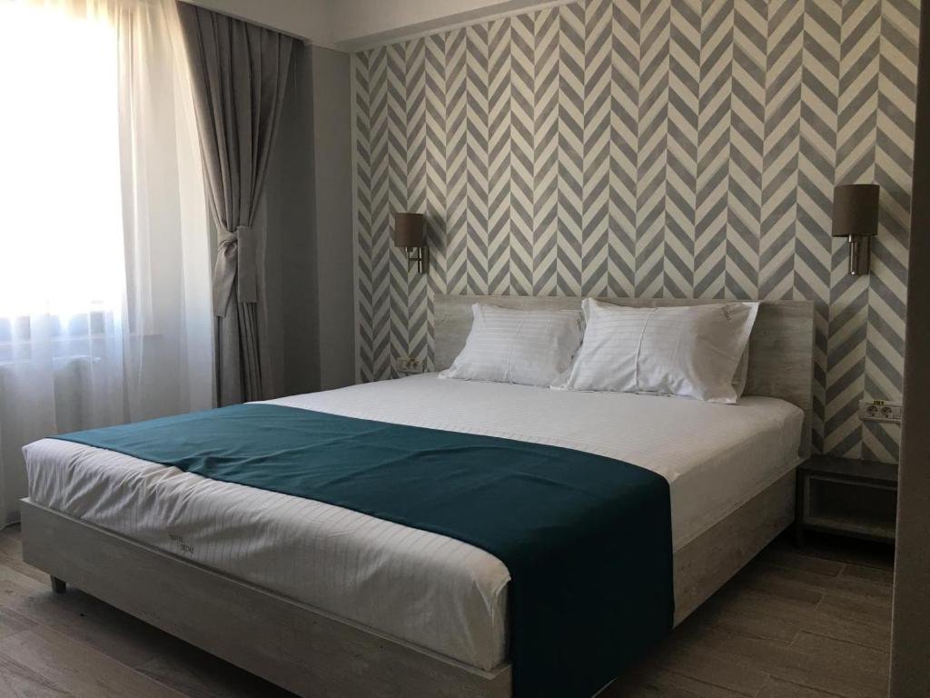 Postel nebo postele na pokoji v ubytování Hotel Dedal