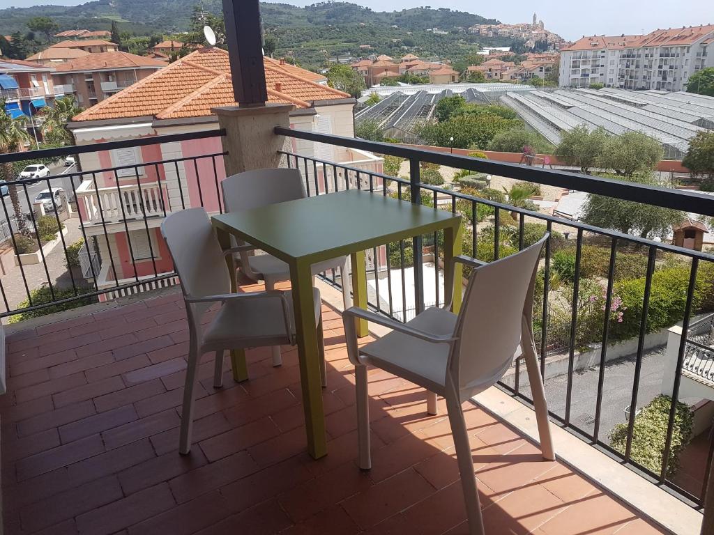 a table and chairs on a balcony with a view at Residence La Meridiana in San Bartolomeo al Mare