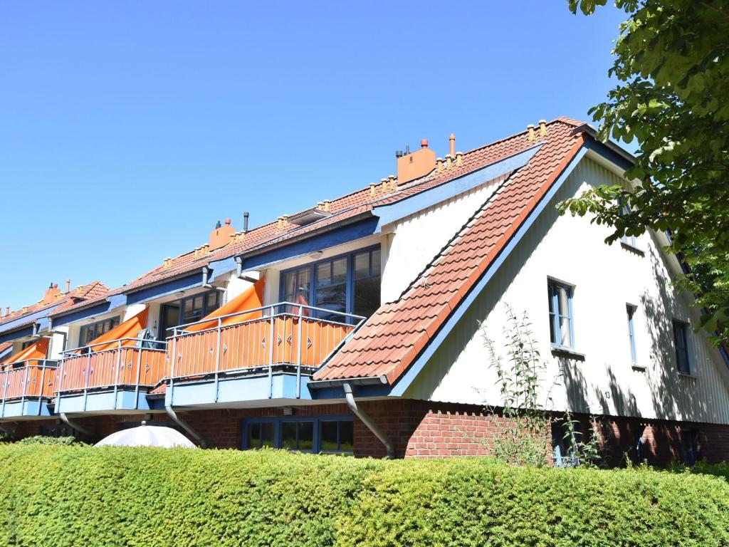 a white house with a deck on the side of it at Charming Apartment in Boltenhagen with Terrace in Boltenhagen