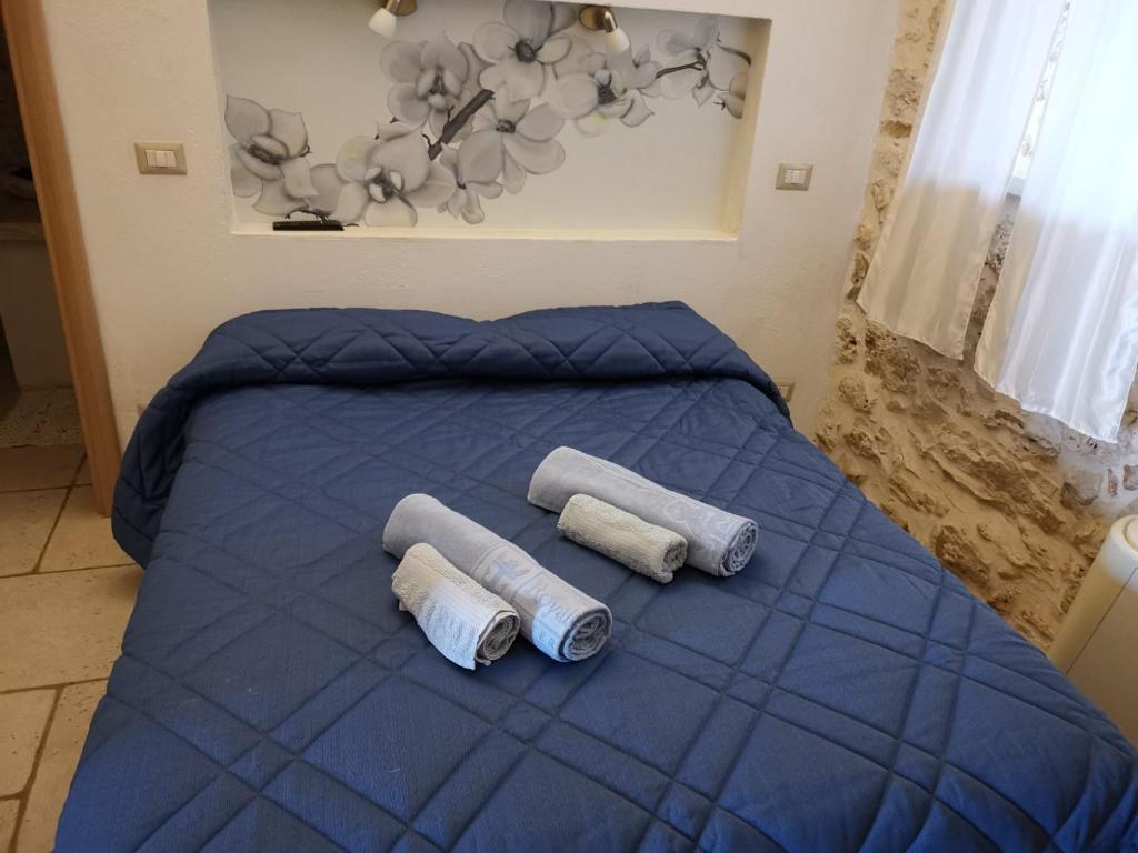 Łóżko lub łóżka w pokoju w obiekcie Trullo Madia e Dimora Giorgio