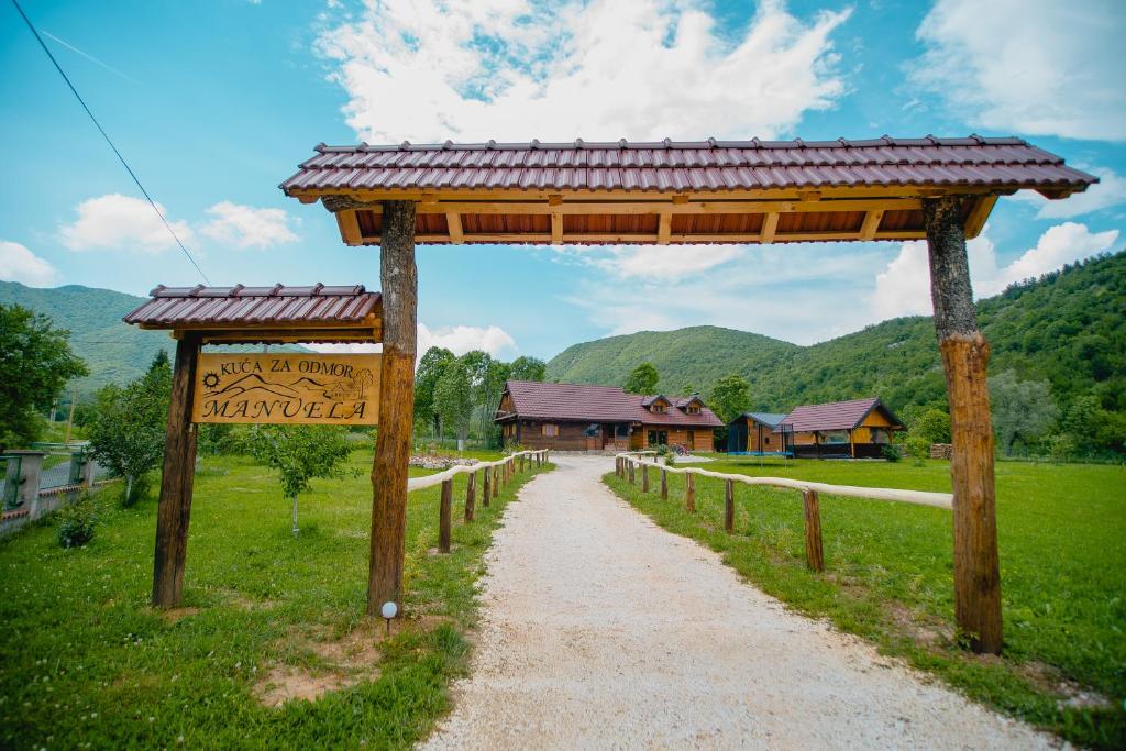 einen Weg mit einem Pavillon und einem Schild auf einem Feld in der Unterkunft Manuela in Gospić