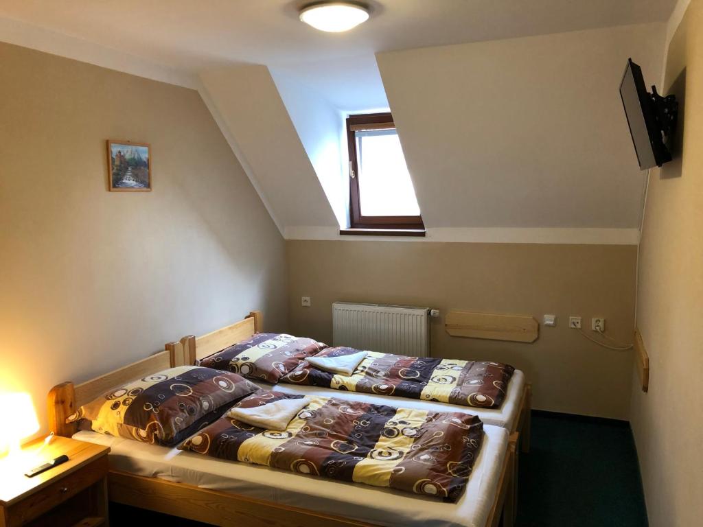 Postel nebo postele na pokoji v ubytování Penzion Samorost