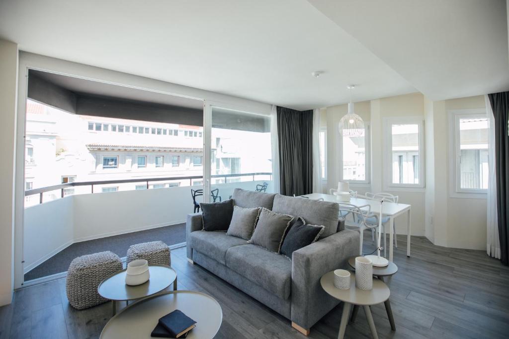 a living room with a couch and a table at BN SUITES Rambla in Alicante