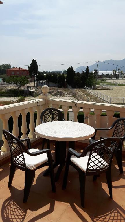 a table and chairs on a balcony with a view at Oliva Nova Golf in Oliva