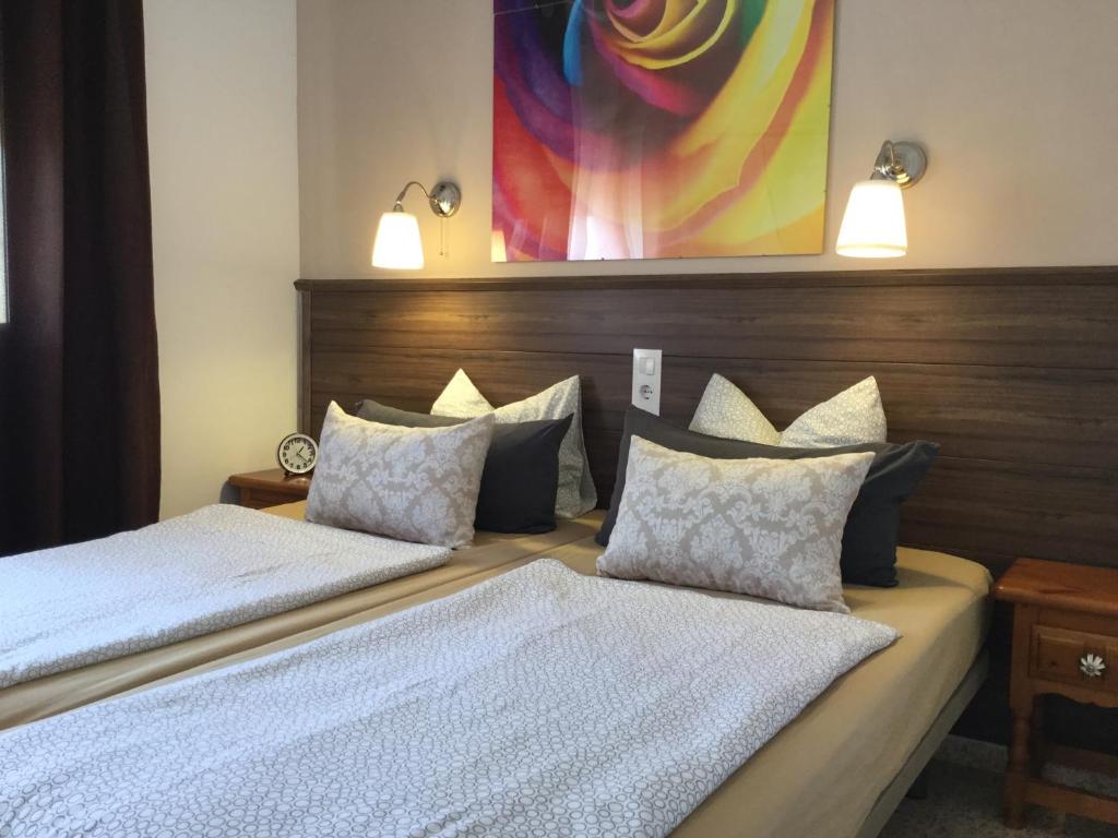 a bedroom with two beds and two lights on the wall at Apartman Dénia in Denia