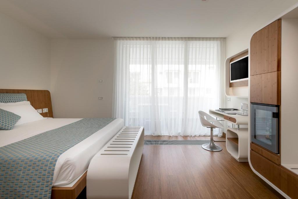 Postel nebo postele na pokoji v ubytování T-Suite Hotel