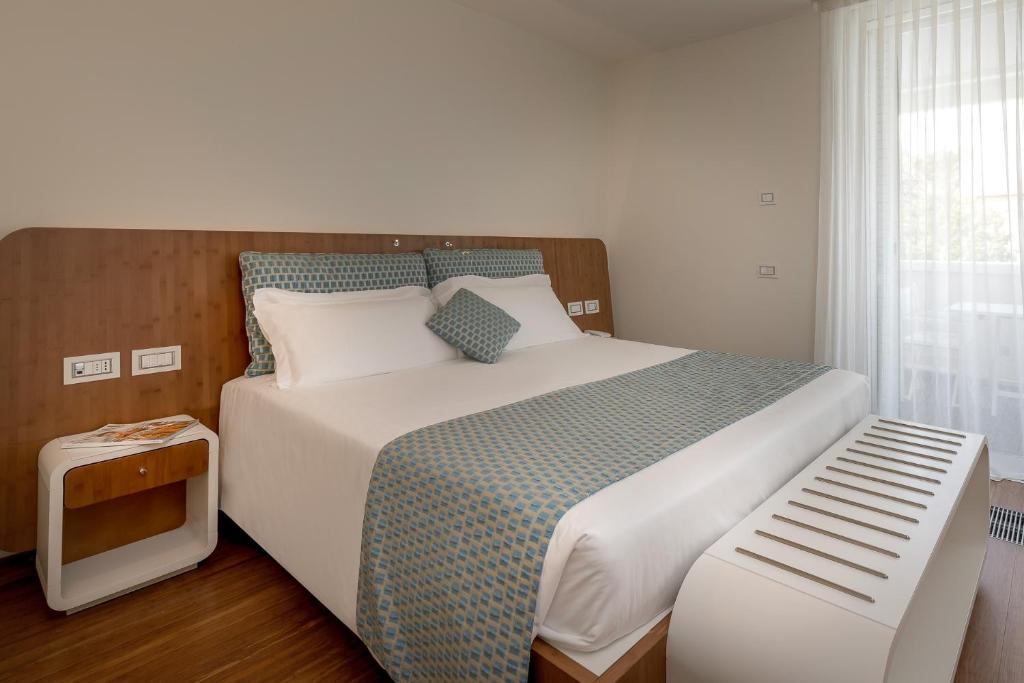 Postel nebo postele na pokoji v ubytování T-Suite Hotel