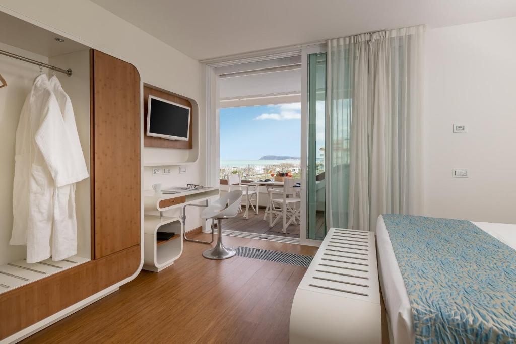Postel nebo postele na pokoji v ubytování T-Suite Hotel