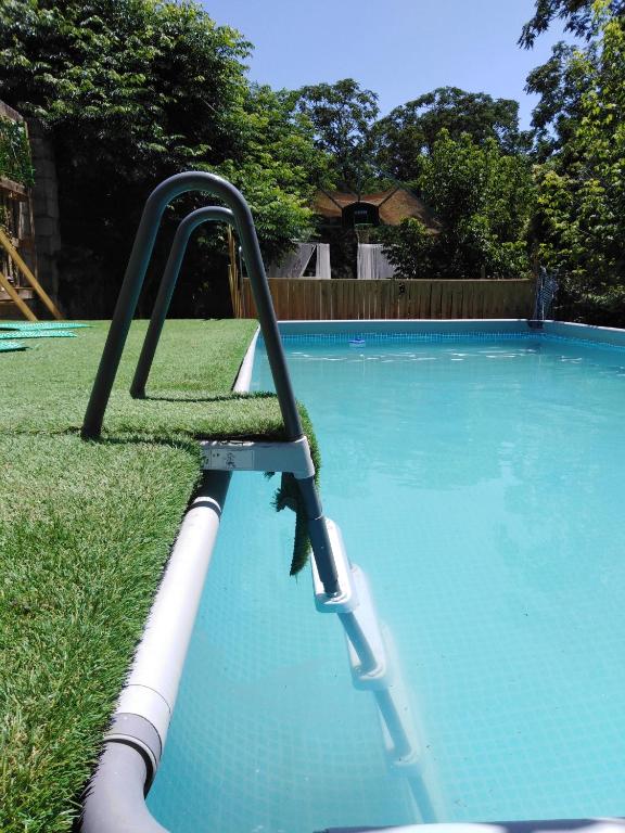 a swimming pool with a slide in the grass at Finca El Naranjo in Seville
