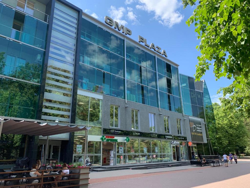 a building with people sitting outside of it at Küüni 5b Guest Apartment in Tartu