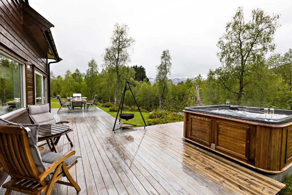 a jacuzzi tub on a wooden deck at Riverside in Hornindal