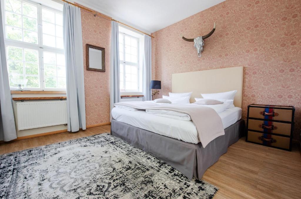 a bedroom with a large bed and a rug at Design Apartments - "Im Holländerviertel" in Potsdam