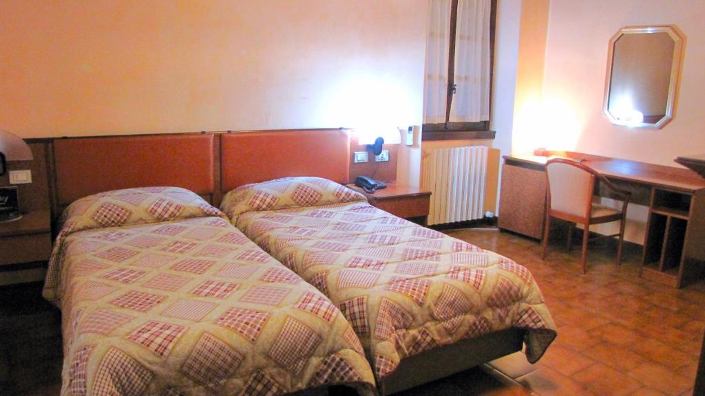 Łóżko lub łóżka w pokoju w obiekcie Agriturismo Cassinazza