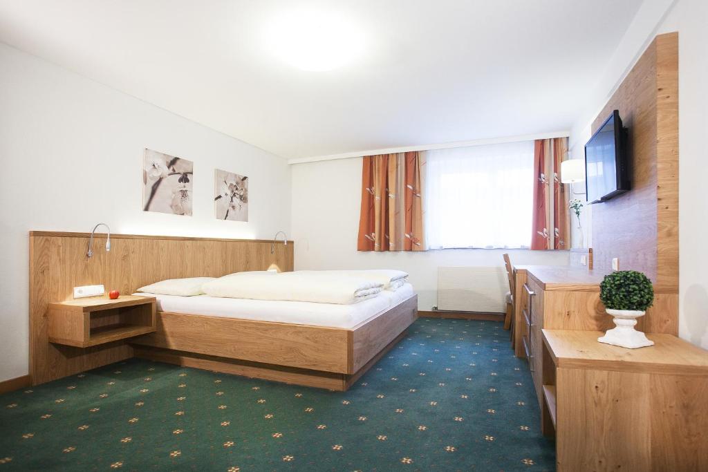 Postel nebo postele na pokoji v ubytování BUSSLEHNER Apartments
