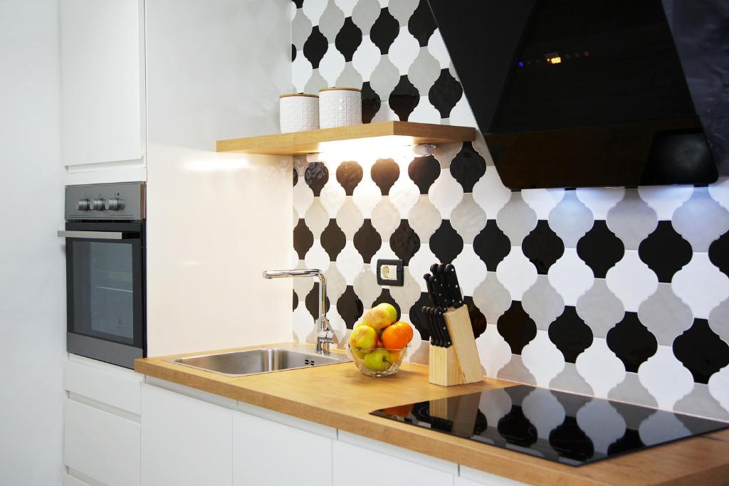 a kitchen with a sink and a bowl of fruit at Apartments Perkovic in Fažana