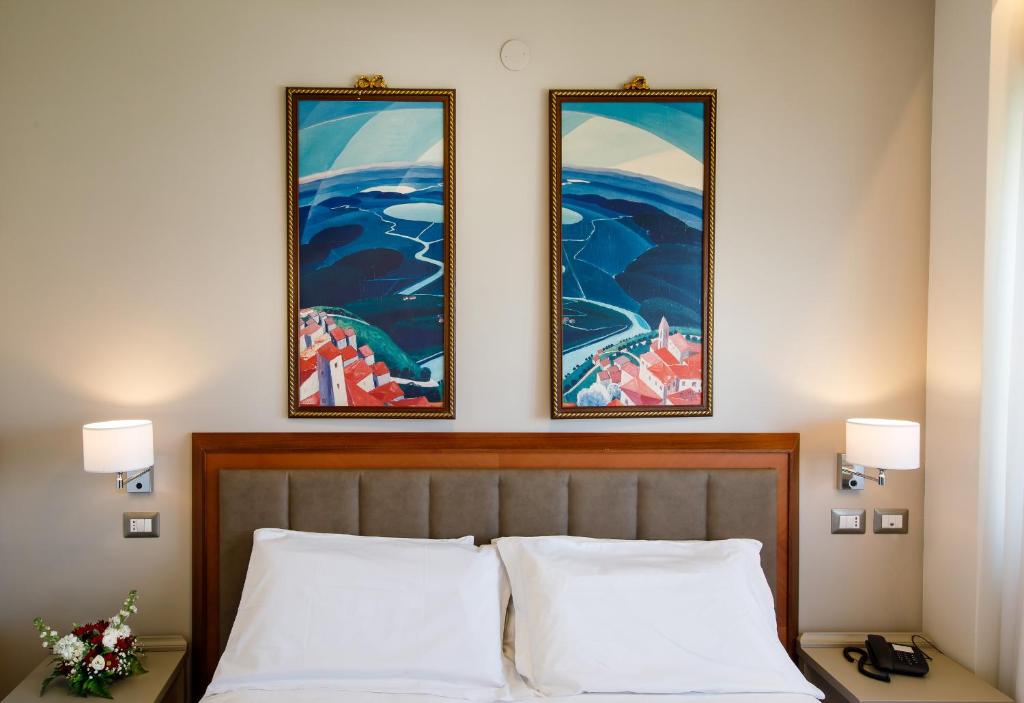 Postel nebo postele na pokoji v ubytování Hotel Lidò