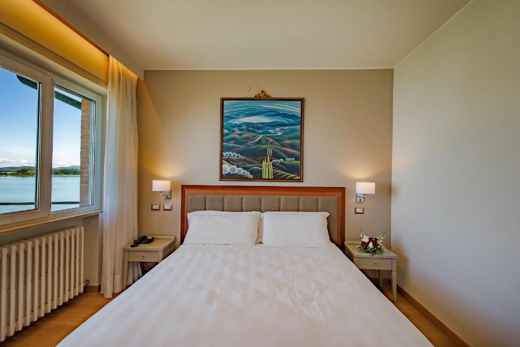 Postel nebo postele na pokoji v ubytování Hotel Lidò