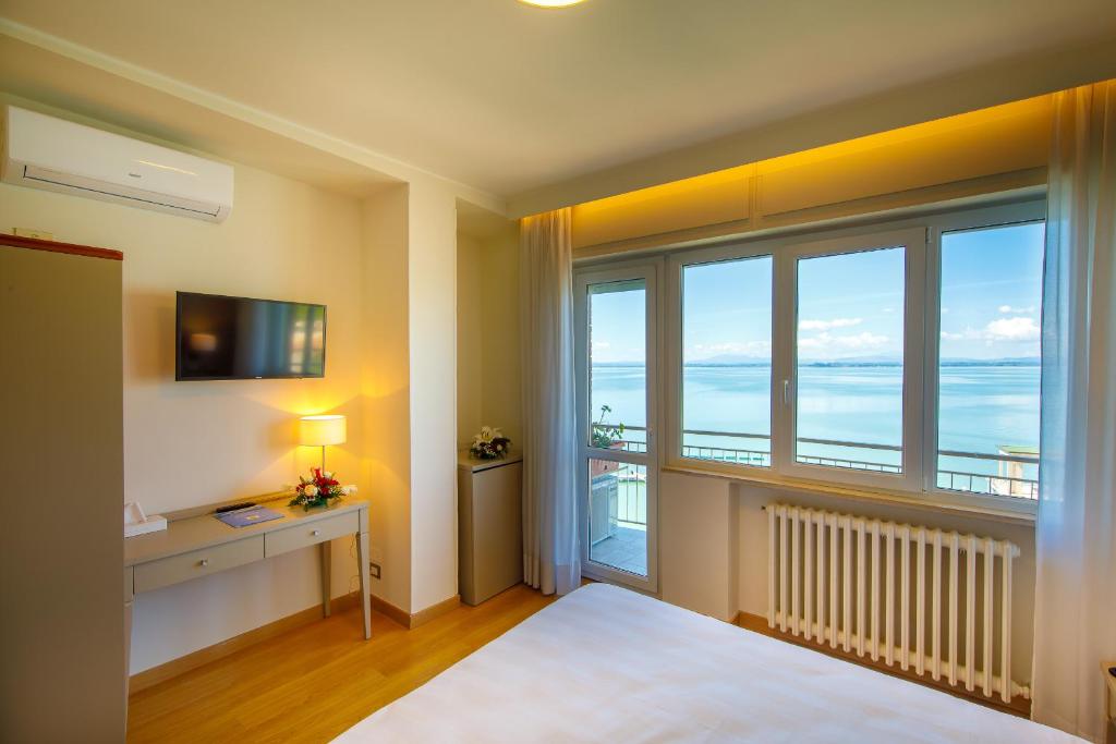 Postel nebo postele na pokoji v ubytování Hotel Lidò