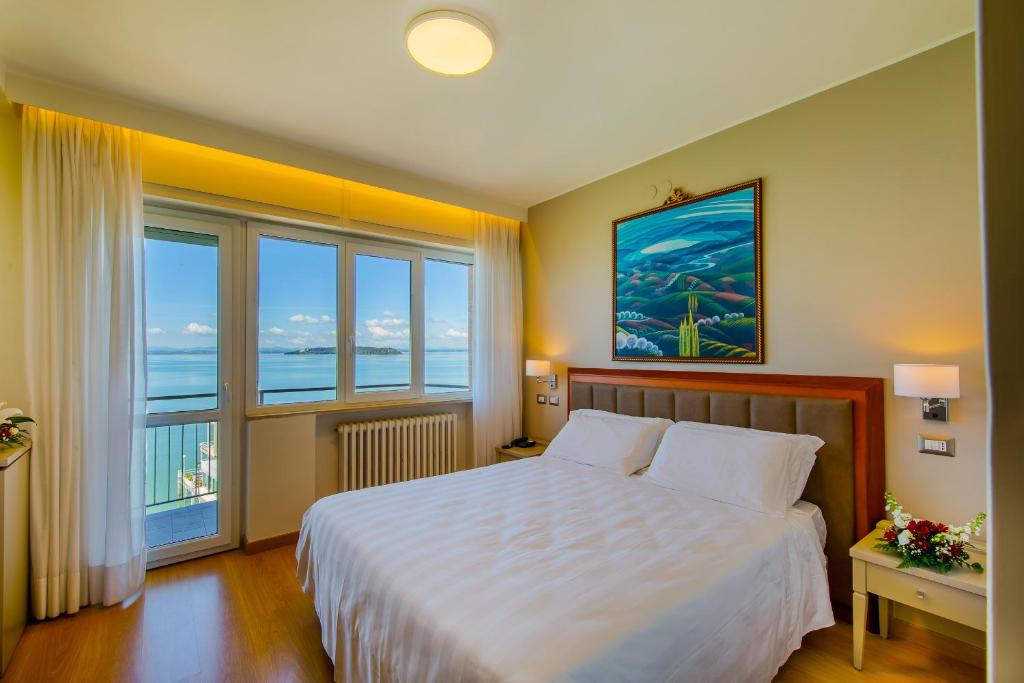Postel nebo postele na pokoji v ubytování Hotel Lidò