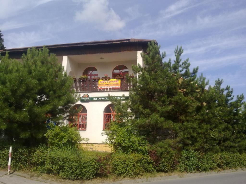 a white building with a balcony on top of it at Studánka in Orlová