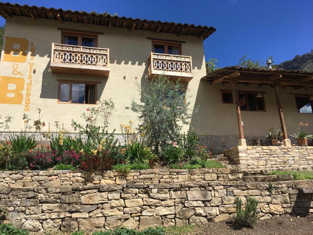a house with two balconies on top of a stone wall at Los Viajeros B&B in Leimebamba