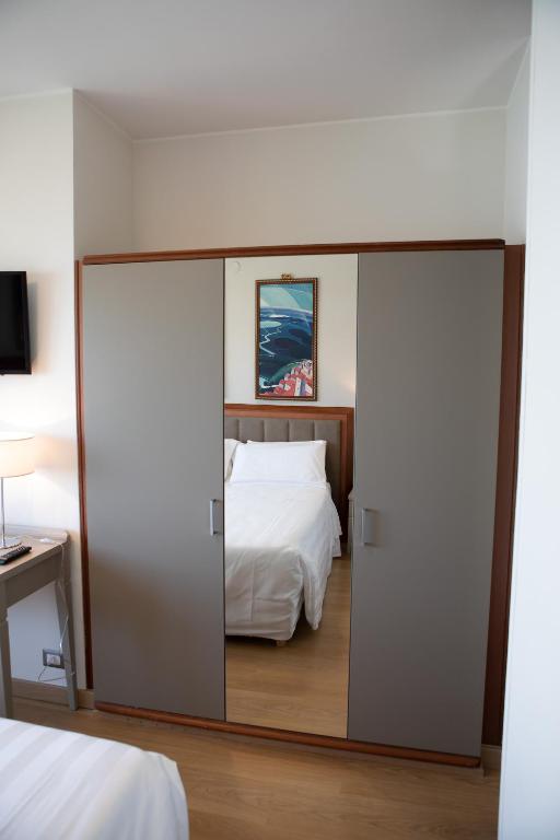 Postel nebo postele na pokoji v ubytování Hotel Lidò