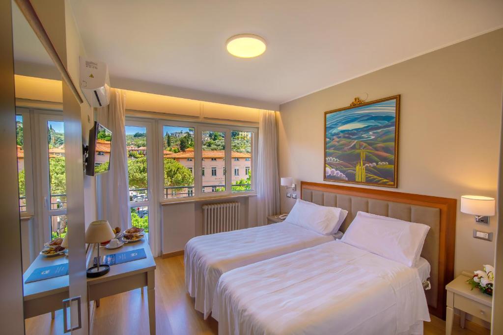 Postel nebo postele na pokoji v ubytování Hotel Lidò