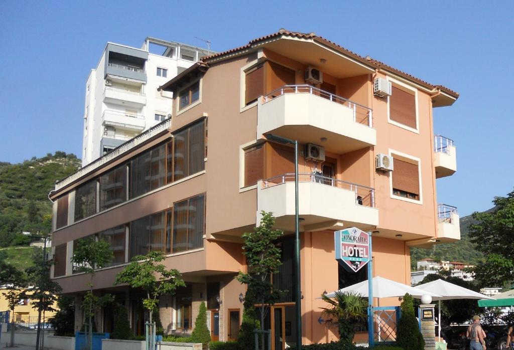 a tall building with people standing outside of it at Onorato Hotel in Vlorë